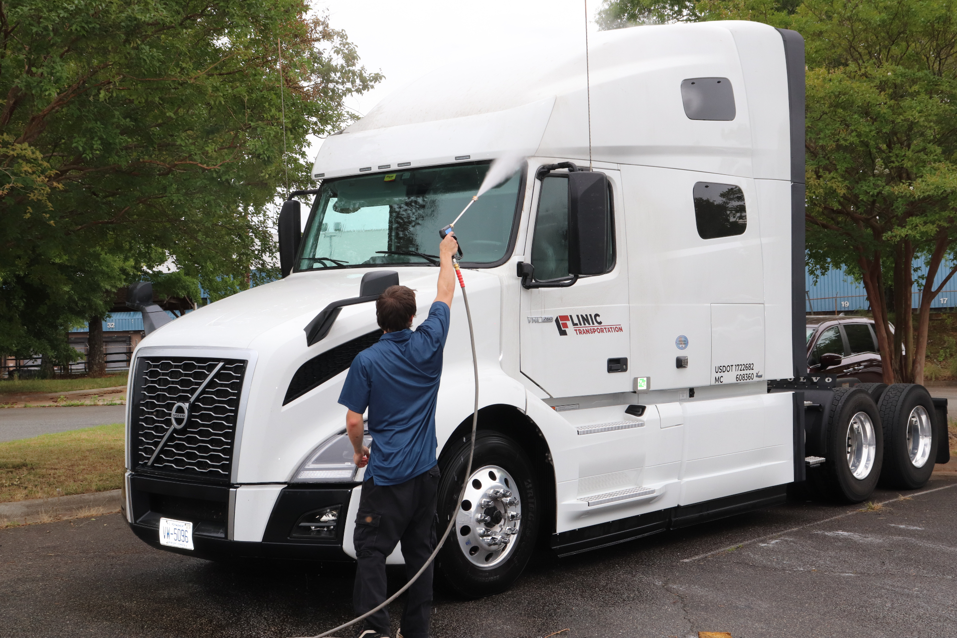 Professional crew washing a commercial truck on site